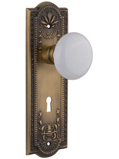 Meadows Style Mortise Lock Set in Antique Brass with White Porcelain Door Knobs.